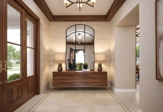 A refined residential entryway with a natural wood console, framed mirror, restrained accessories and complementary architectural finishes.